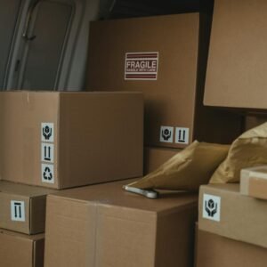Neatly organized cardboard boxes inside a delivery van, ready for shipment.